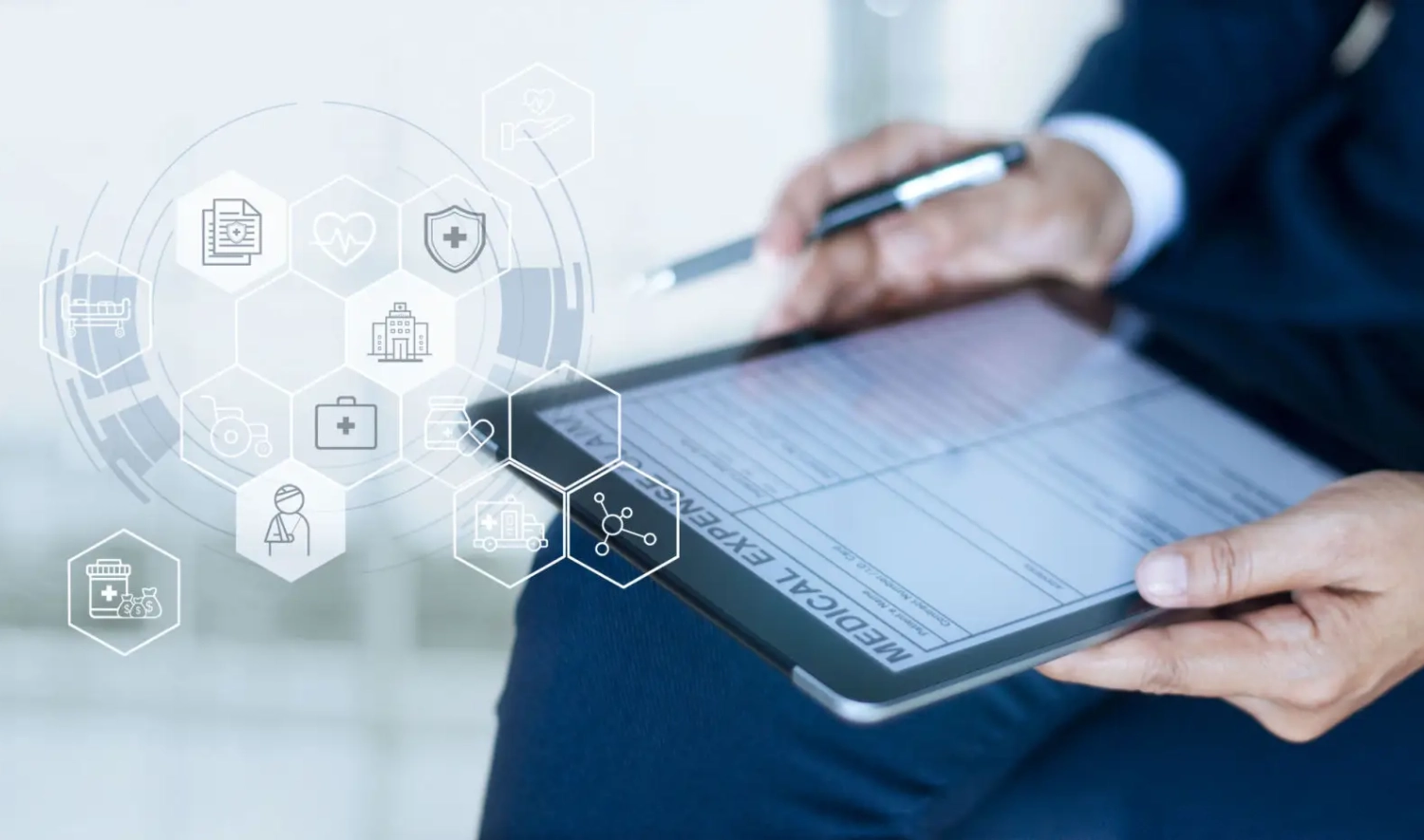 Person holding tablet with healthcare icons overlay.