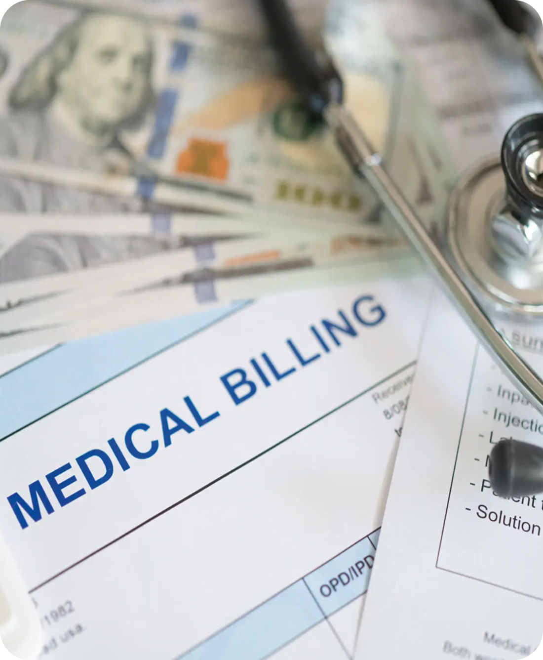 Medical billing documents with money and stethoscope.