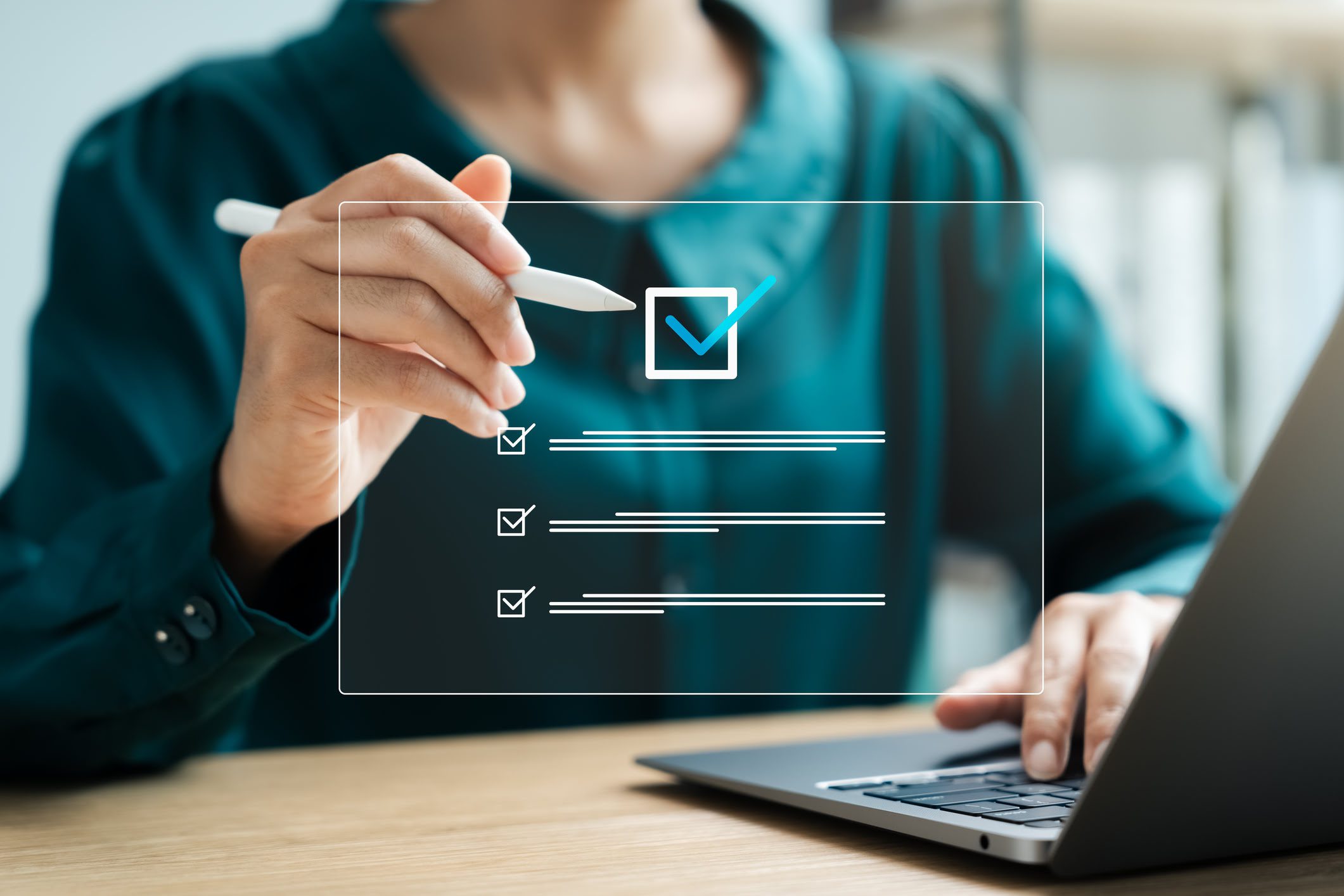 Person using laptop with digital checklist.